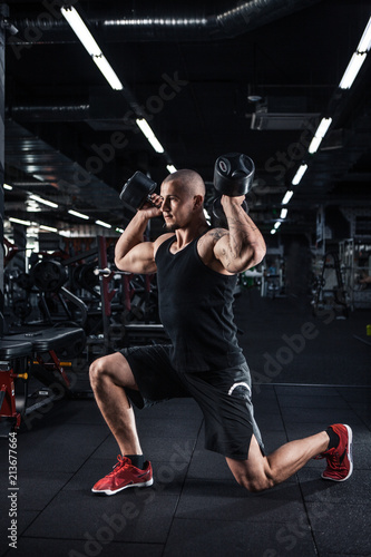 Muscular man during workout in the gym