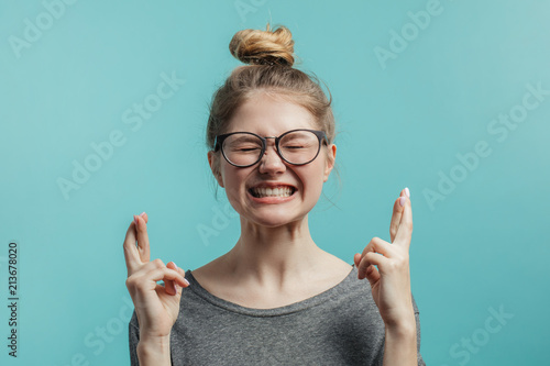 Obraz na płótnie Portrait of overjoyed young caucasian woman with hairbun style lifting fists wit