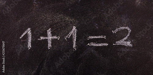 simple equation 1+1=2 isolated, on blackboard background.
