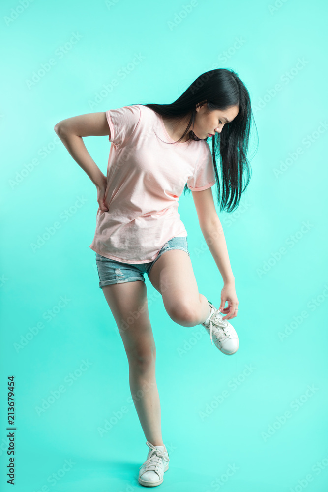 Asian sporty woman with long hair in denim shorts adjusting laces on her  boots. Beautiful Asian girl oriental girl black hair long teenager young  model student pretty Stock Photo | Adobe Stock