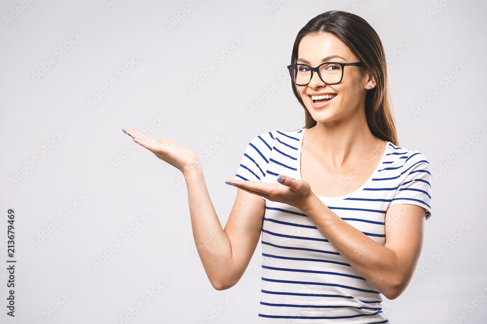 Young beautiful woman presenting your product, isolated over white background. Place for text. Female hand pushing a digital screen at office background. Focus on finger. Young beautiful woman presenting your product, isolated over white background. Place for text. Female hand pushing a digital screen at office background. Focus on finger.