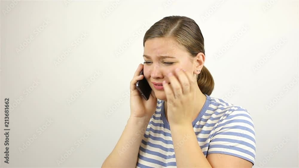 Young beautiful woman talking on the phone. bad news. Young beautiful woman talking on the phone. bad news.