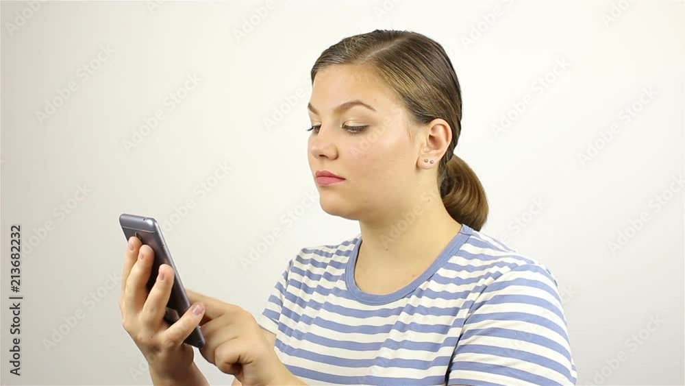 Young beautiful woman hand writing SMS, texting on smartphone. Young beautiful woman hand writing SMS, texting on smartphone.