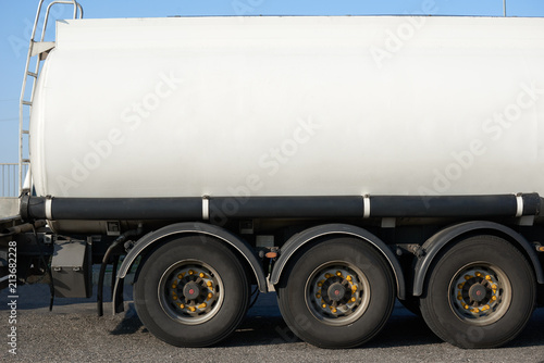 white blank tank truck, side view closeup, one object on road