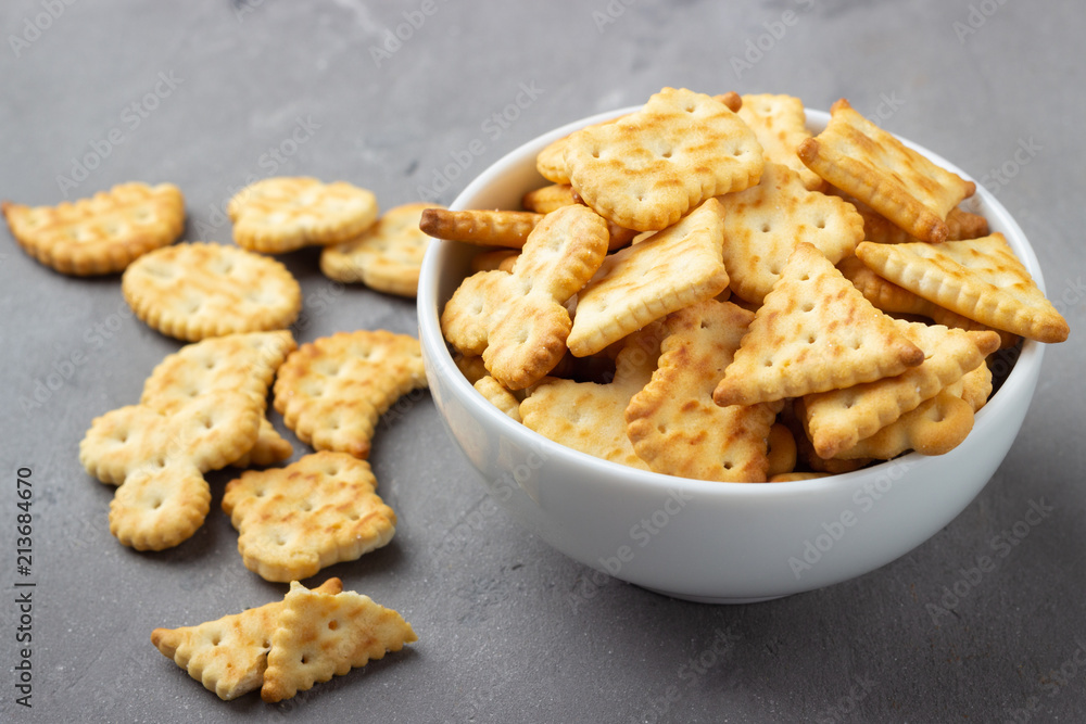 Dry salty cracker cookies on gray stone background. Dry salty cracker cookies on gray stone background.