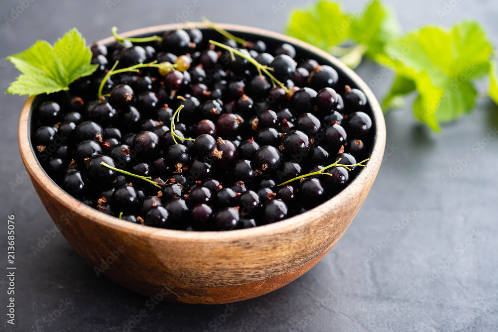 Blackcurrant berries with leaves, blackcurrant in a bowl. Blackcurrant berries with leaves, blackcurrant in a bowl.