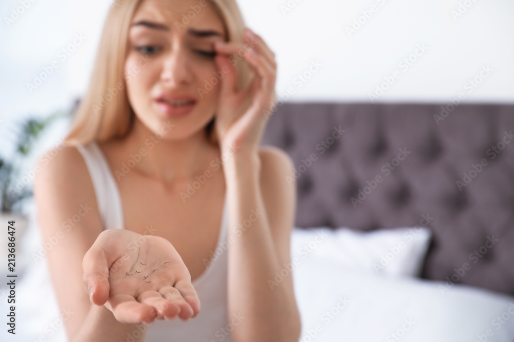 Fototapeta premium Young woman with eyelash loss problem indoors