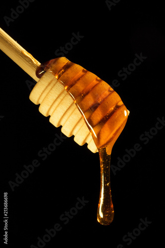 Sweet honey on the black background 