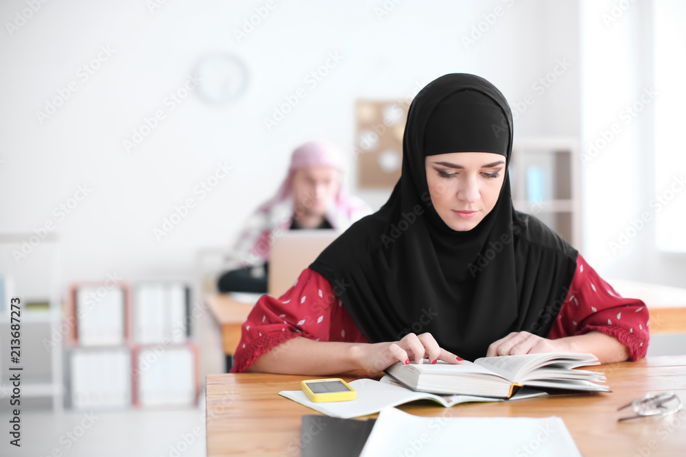 Muslim student wearing traditional clothes in classroom Muslim student wearing traditional clothes in classroom