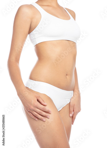Young woman showing smooth skin after bikini epilation on white background
