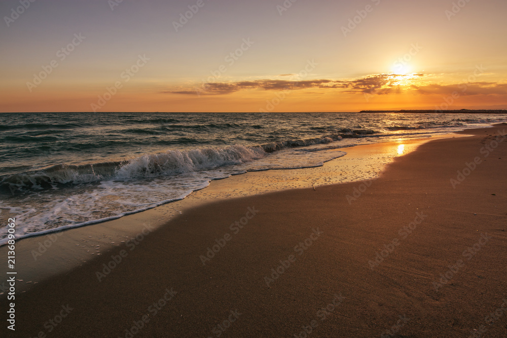 Tropical beach and mediterranean sea on sunset background