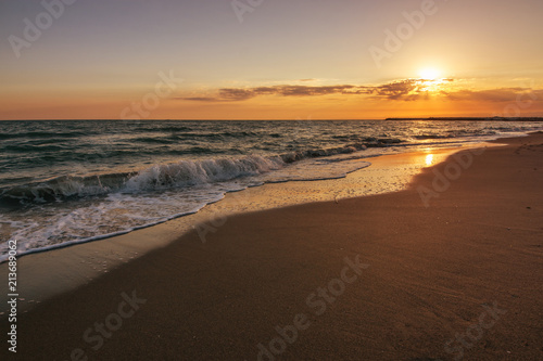 Tropical beach and mediterranean sea on sunset background