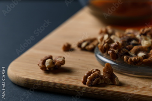 Healthy Breakfast ingredients: honey, walnuts on a dark background. Healthy diet. Close up.