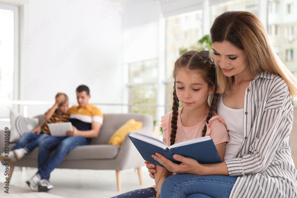 Mother reading book with child at home. Happy family Mother reading book with child at home. Happy family