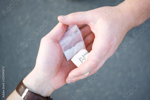 Drug selling concept. Close up hands, trading meth. photo