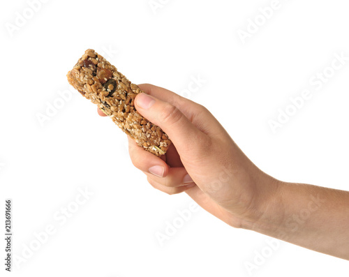 Woman holding grain cereal bar on white background. Healthy snack