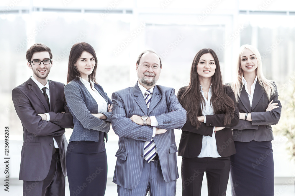 portrait of successful businessman and business team standing together with arms crossed in front of him portrait of successful businessman and business team standing together with arms crossed in front of him