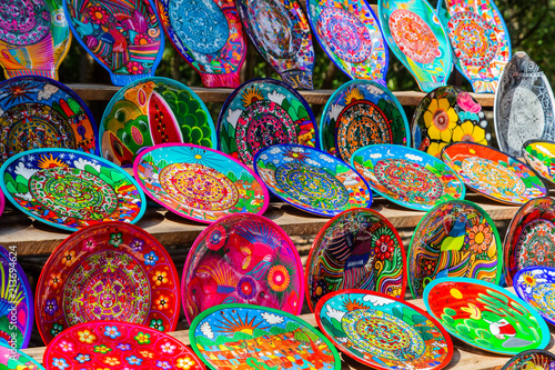 Souvenirs on the market at Chichen Itza. Maya Indians plates. Beautiful bright dishes, plates. Colorful Cookware