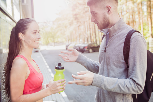 young couple runners talking on the street, the concept of a healthy lifestyle