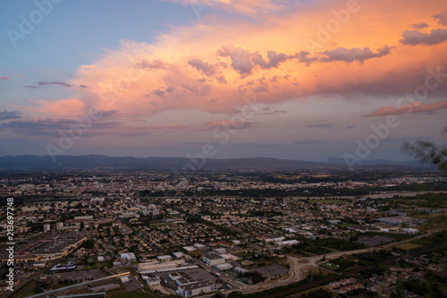 Stunning reddish sunset on Valence city with mountains on the background in french Rhone-Alpes region. Top view.