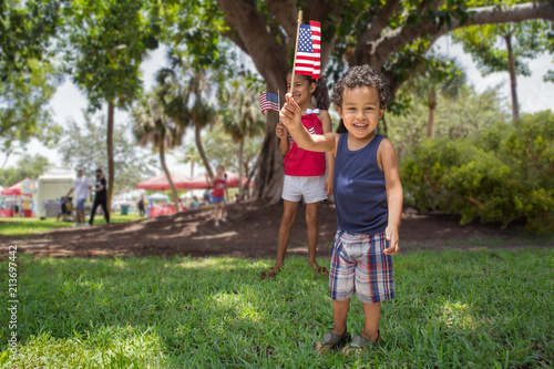Siblings at the park celebrate the 4th of July.