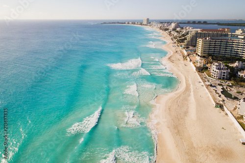 Cancun beach panorama aerial view. Aerial view of Caribbean Sea beach. Zona hotelera top view. Beauty nature landscape with tropical beach. Caribbean seaside beach with turquoise water and big wave