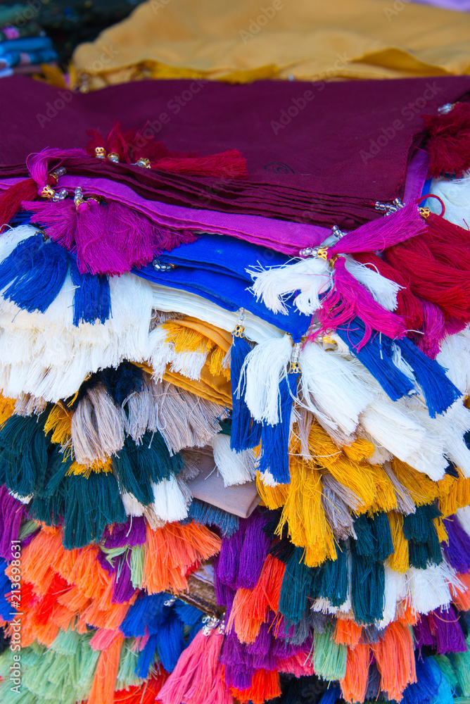 tasseled fabrics on market stall in sanliurfa, turkey