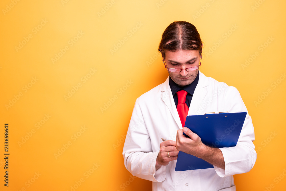 Male doctor signing prescription diagnostic Male doctor signing prescription diagnostic