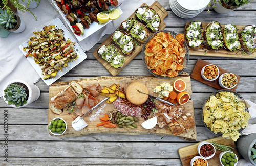 Overhead view of various food served on wooden table