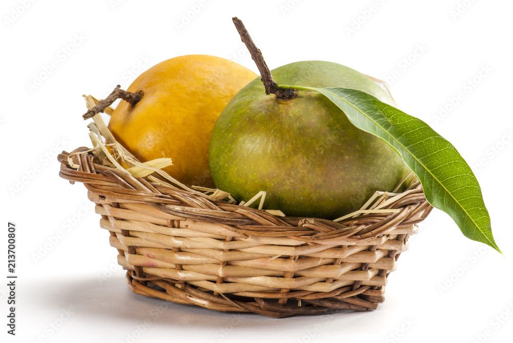 Mangoes in cane basket isolated on white background Mangoes in cane basket isolated on white background