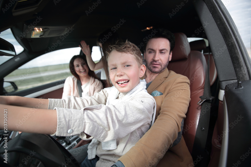happy son driving a car. happy son driving a car.