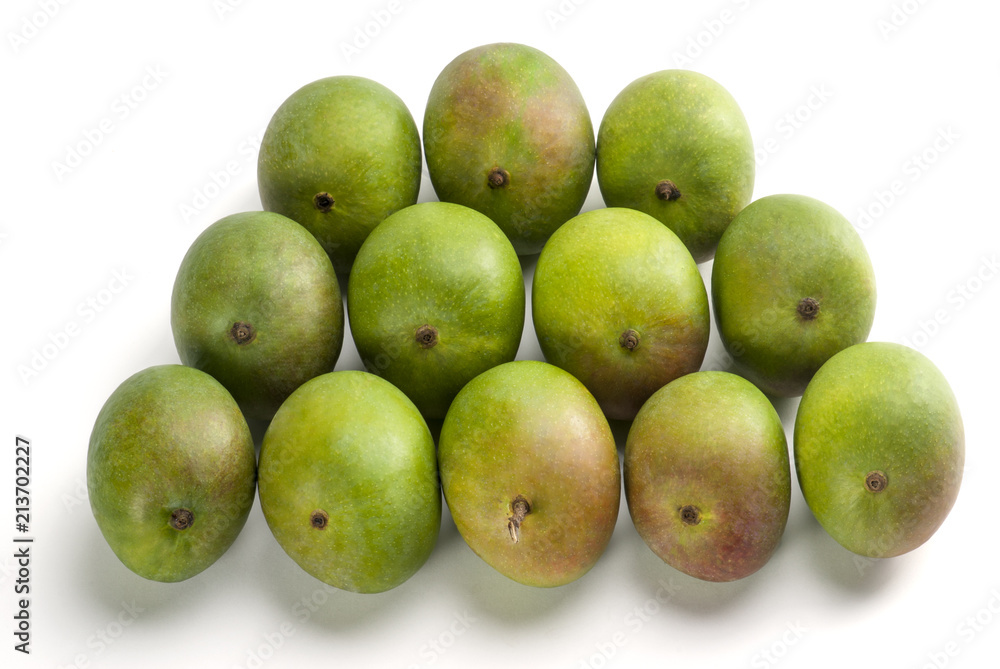 Raw Mangoes arranged on table top indoor Raw Mangoes arranged on table top indoor