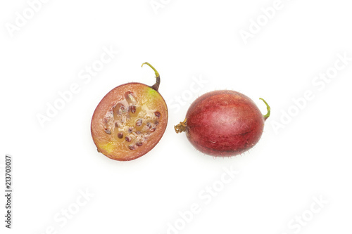 Group of one whole one half of fresh red gooseberry hinnomaki variety flatlay isolated on white photo