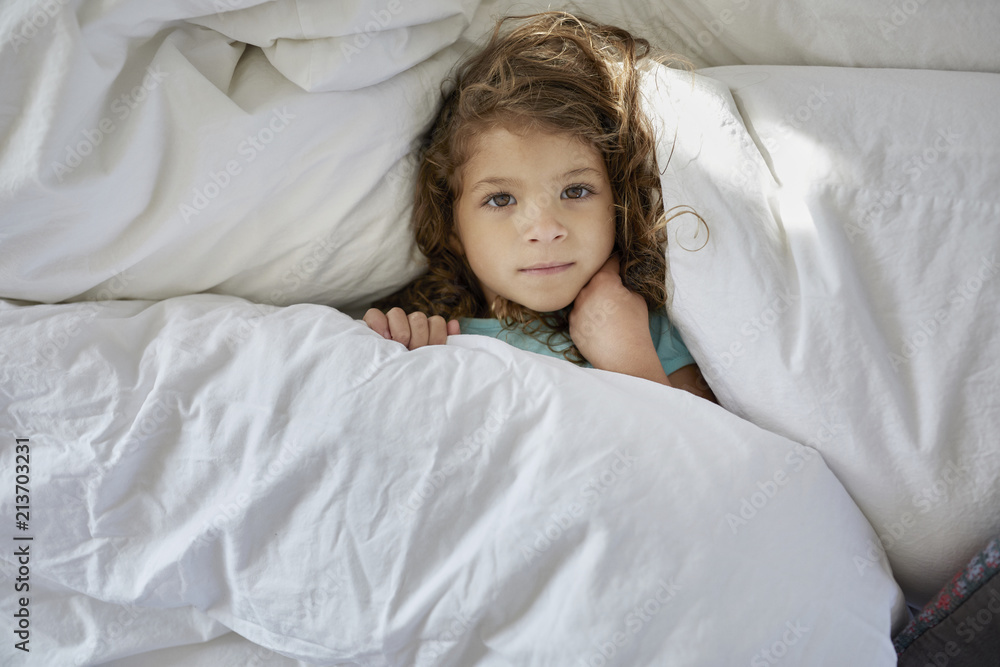 High angle portrait of girl lying on bed at home High angle portrait of girl lying on bed at home