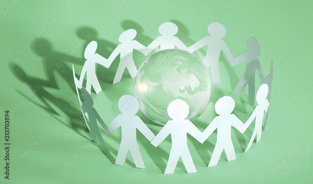 group of paper men standing around the glass globe