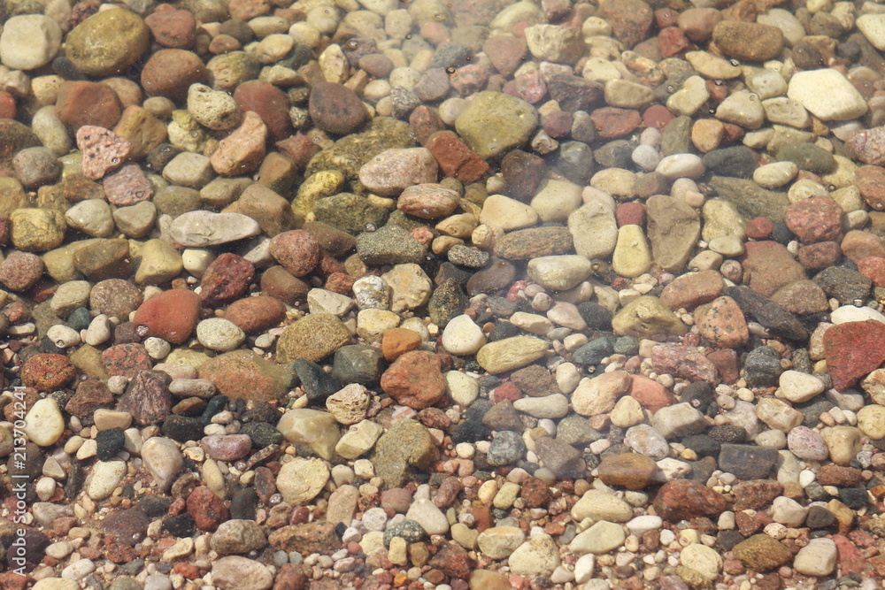 Pebbles in the beach water background Pebbles in the beach water background