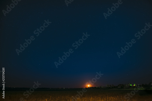 Moonrise Above Belarusian Village In Eastern Europe. Belarusian 