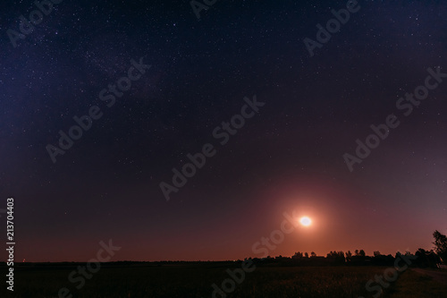 Moonrise Above Summer Meadow Landscape In Starry Night