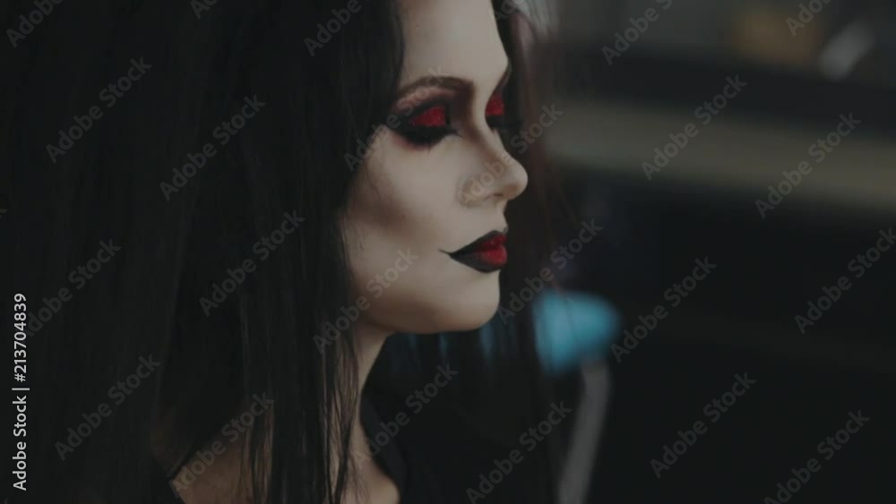 Halloween party. Stylist does the hairstyle on the head of a brunette woman for a Halloween party. Halloween party. Stylist does the hairstyle on the head of a brunette woman for a Halloween party.