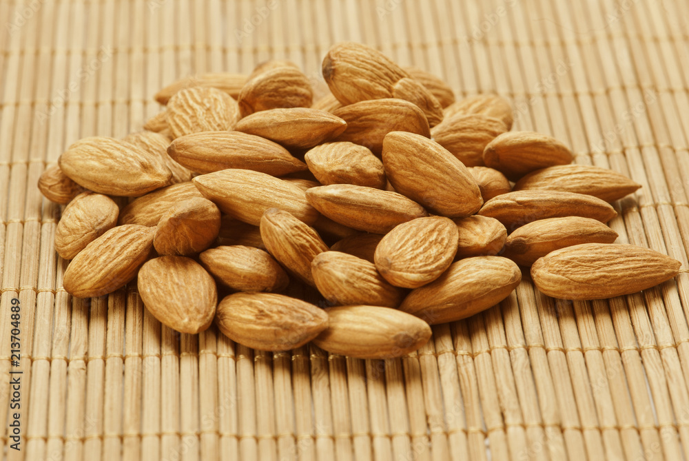 Fototapeta premium Almonds on wooden background
