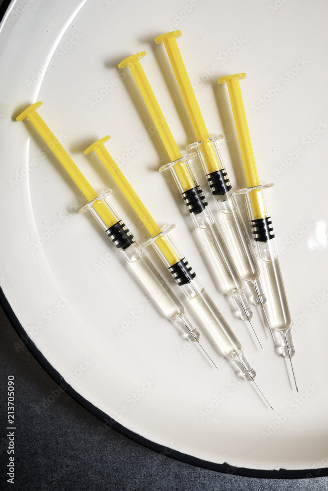 Overhead view of medicine containing syringes on table in hospital Overhead view of medicine containing syringes on table in hospital