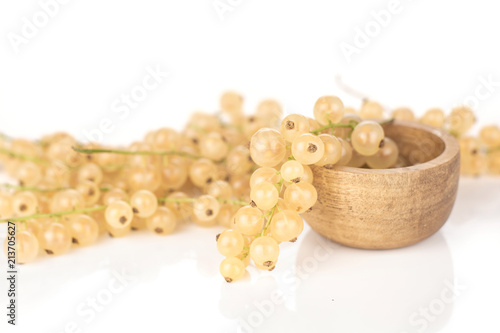 Fresh white currant berry blanka variety one strig in a wooden bowl composition isolated on white photo