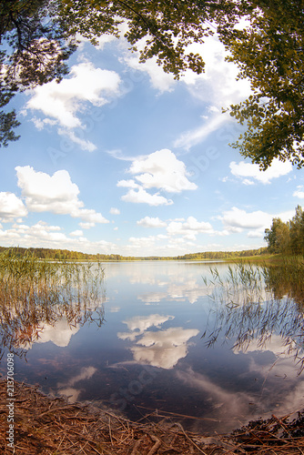 Lake on a summer day with the reflection of clouds in the water. Summer landscape. © pushann