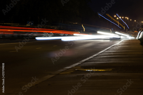 traces of car headlights on a night street