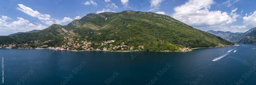 Aerial panoramic beautiful view from above to Kotor Bay and regular passenger ferry from Lepetane to Kamenari by a sunny afternoon