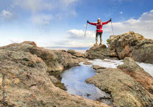 hiker enjoying reaching mountain top