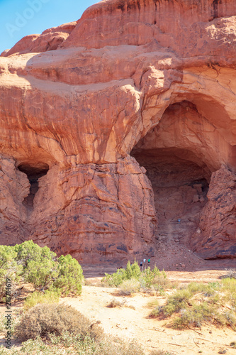 The start of a new arch within the Double Arch formation along The Windows Trail in Arches National Park with rock climbers