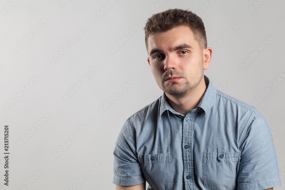 Closeup portrait of handsome unhappy man with bad mood Closeup portrait of handsome unhappy man with bad mood