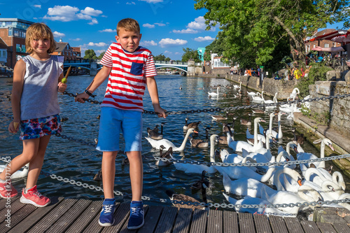 Children and Eton-Windsor bridge over the river Thames in the evening photo