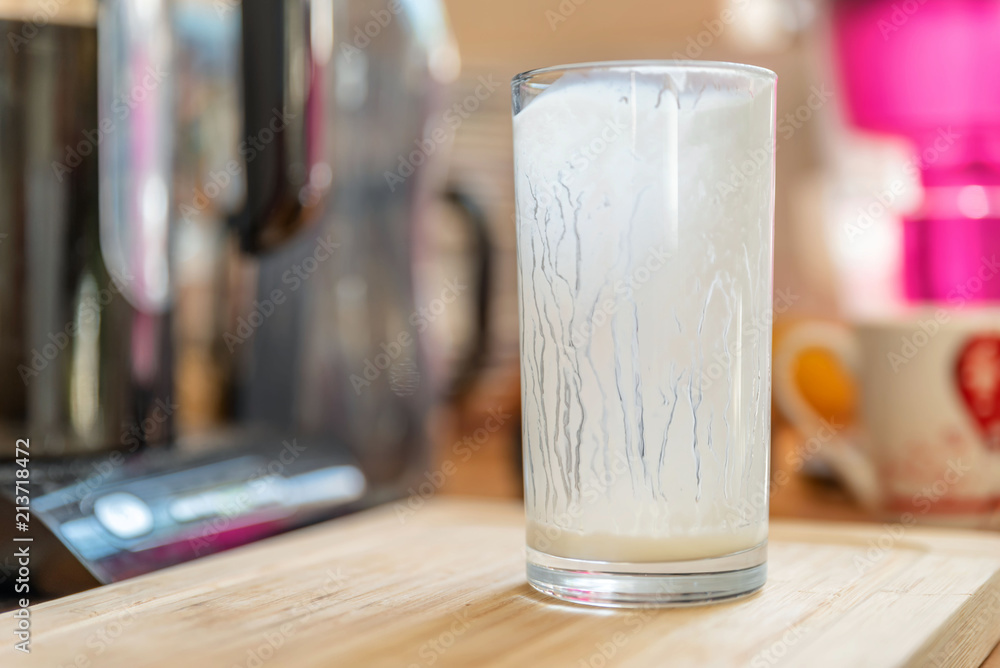 Closeup view of empty glass of fresh kefir probiotik drink on wooden kitchen table Closeup view of empty glass of fresh kefir probiotik drink on wooden kitchen table